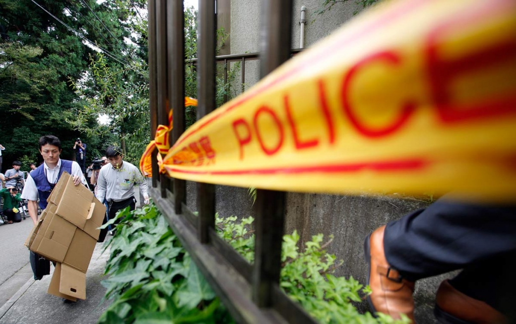 Police officers enter into the house of Satoshi Uematsu the suspect in a mass stabbing attack in Sagamihara outside of Tokyo Wednesday