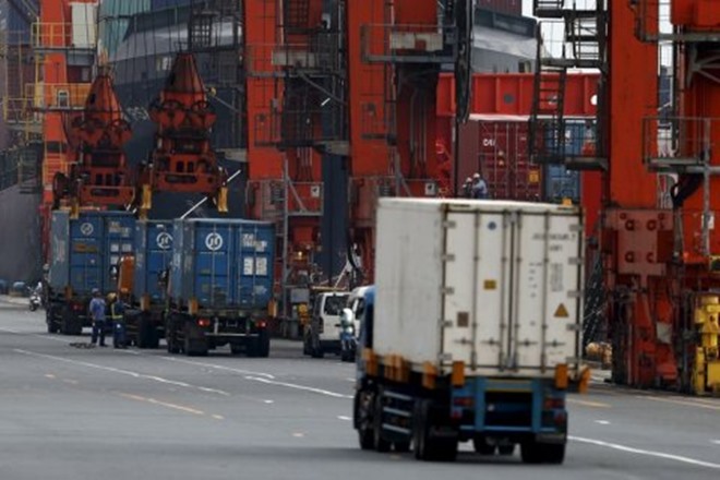 A sharp drop in oil and gas prices took pressure off Japan's trade balance but exports still struggled to make headway with a sharp rise in the yen weighing on profits among some of Japanese biggest firms