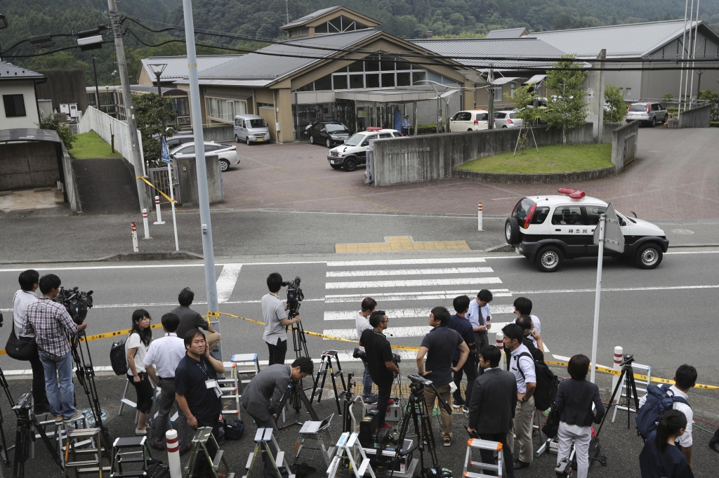 Journalists gather in front of Tsukui Yamayuri-en an assisted care facility where at least 19 people were killed and dozens injured in a knife attack in Sagamihara outside Tokyo Tuesday