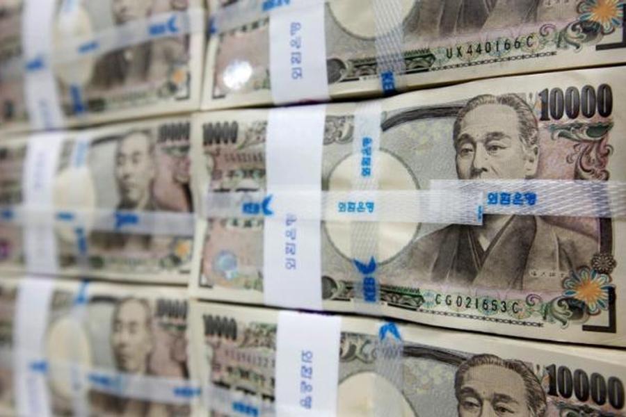 Japanese yen notes are piled up after counting at a bank during