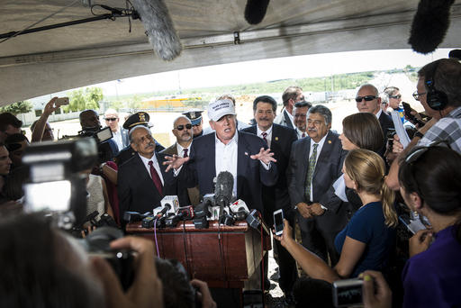 Republican Presidential candidate and business mogul Donald Trump talks to the media along the U.S. Mexico border during his trip to the border