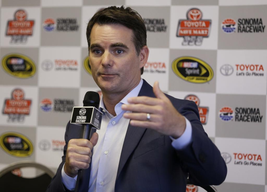 INDIANAPOLIS IN- JULY 27 Jeff Gordon driver of the #24 Axalta Chevrolet celebrates with the trophy after winning the NASCAR Sprint Cup Series Crown Royal Presents The John Wayne Walding 400 at the Brickyard Indianapolis Motor Speedway