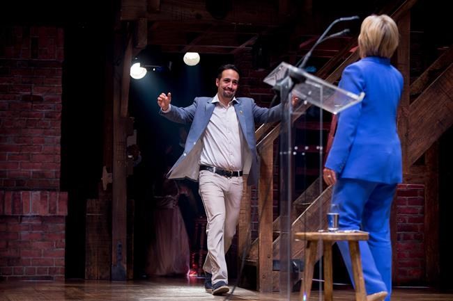 Hamilton creator Lin Manuel Miranda reaches to hug Democratic presidential candidate Hillary Clinton after she speaks briefly on stage following a Ôøºspecial performance of the broadway show Hamilton in Support of the Hillary Victory Fund Thursday Ju