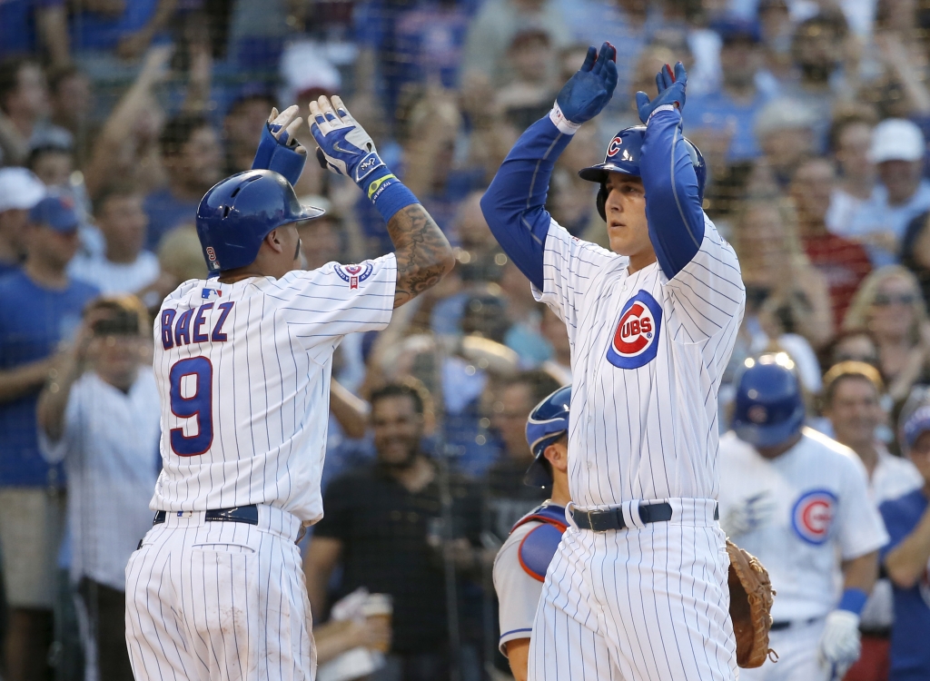 Chicago Cubs&#039 Anthony Rizzo right celebrates his three-run home run off New York Mets starting pitcher Steven Matz with Javier Baez during the third inning of a baseball game Monday