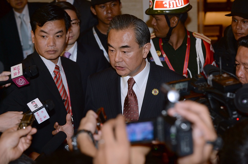 Chinese Foreign Minister Wang Yi speaks to reporters after he met with US State Secretary John Kerry on the sideline of the Association of Southeast Asian Nations annual ministerial meeting and the Regional Security Forum in Vie