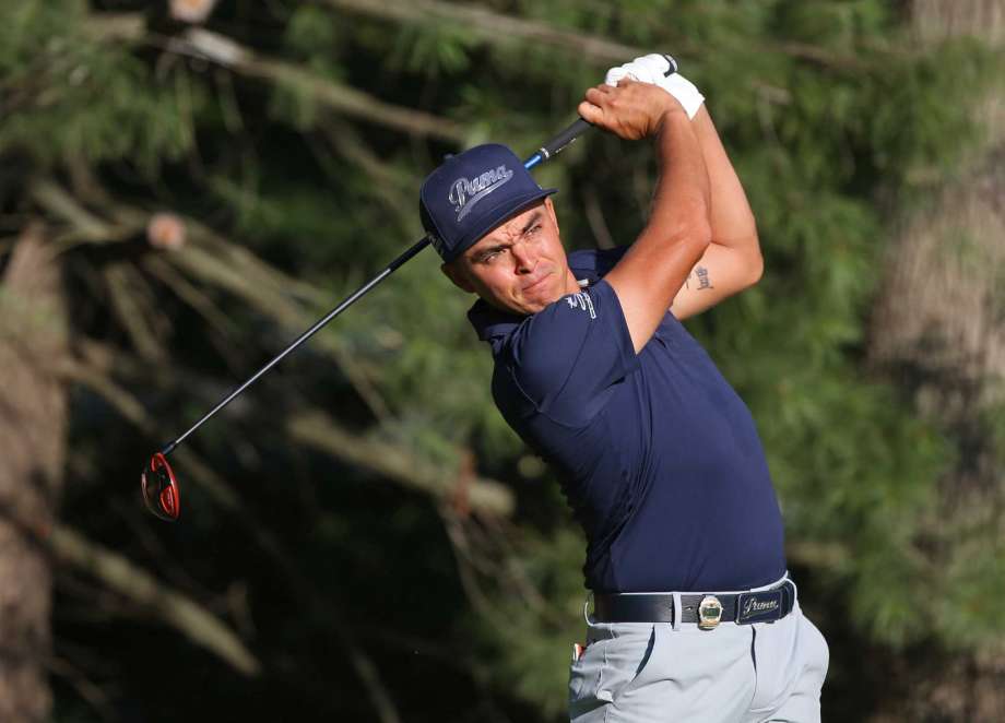 Rickie Fowler watches his tee shot on the 10th hole during the first round of the PGA Championship golf tournament at Baltusrol Golf Club in Springfield N.J. Thursday