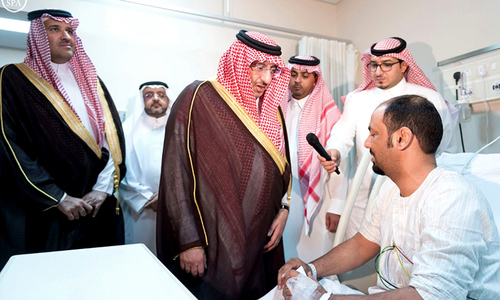 Saudi Crown Prince and Interior Minister Mohammed bin Nayef visits a wounded man who was injured after a suicide bomber detonated a device near the security headquarters of the Prophet's Mosque. ─ Saudi Press Agency  Reuters