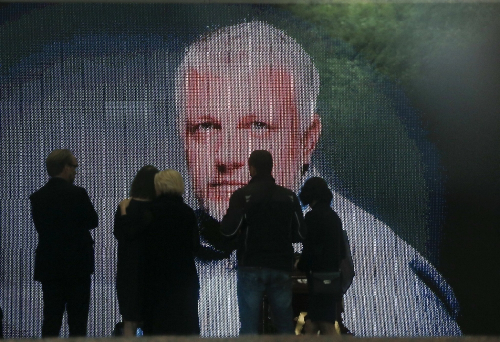 A portrait is displayed as colleagues and people gather at the coffin of Pavel Sheremet to pay their respects at his memorial ceremony in Kiev Ukraine Friday