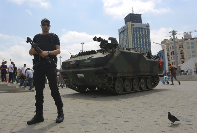 KEMAL ASLAN  Reuters
An abandoned tank is guarded at Taksim Square in Istanbul Turkey