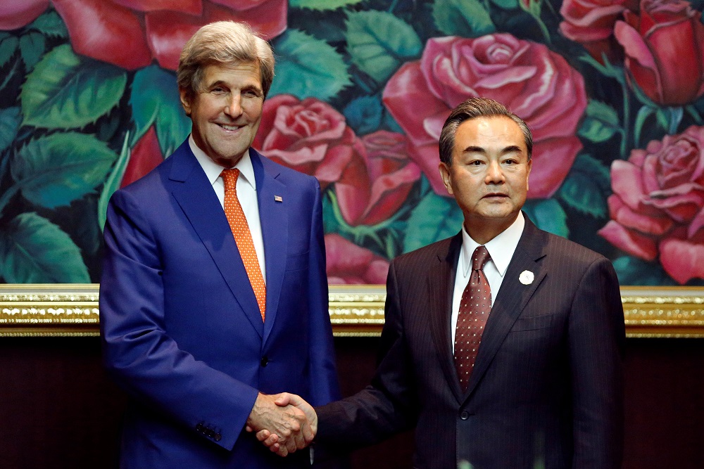 U.S. Secretary of State John Kerry greets China's Foreign Minister Wang Yi during a bilateral meeting at the sidelines of the ASEAN foreign ministers meeting in Vientiane Laos