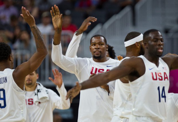 U.S. guard Kevin Durant center greets teammates as they come off the court during a timeout in an exhibition basketball game against Argentina on Friday