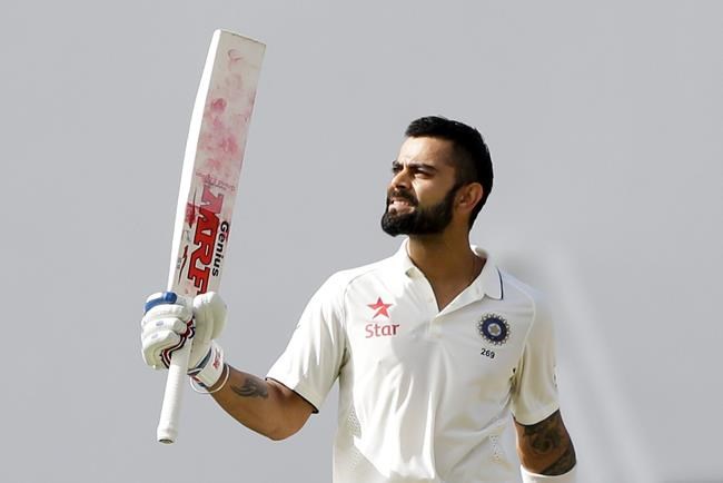 India's captain Virat Kohli celebrates after he scored a century during day one of thei first cricket Test match against West Indies at the Sir Vivian Richards Stadium in North Sound Antigua Thursday