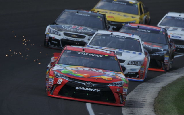 Kyle Busch leads the pack in the opening lap of the Brickyard 400