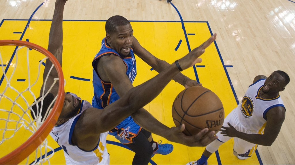 OAKLAND CA- MAY 18 Kevin Durant #35 of the Oklahoma City Thunder goes up for a shot against Festus Ezeli #31 of the Golden State Warriors during game two of the Western Conference Finals during the 2016 NBA Playoffs at ORACLE Arena