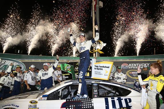 Brad Keselowski celebrates following victory in the Sprint Cup Series Quaker State 400 at Kentucky Speedway Saturday