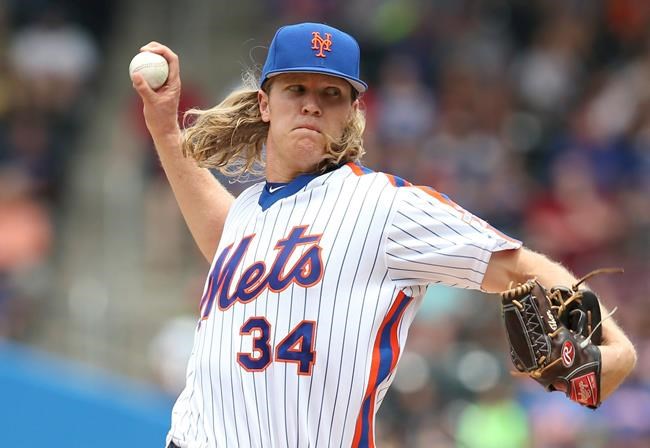 New York Mets starting pitcher Noah Syndergaard throws during the second inning of a baseball game against the Chicago Cubs Sunday