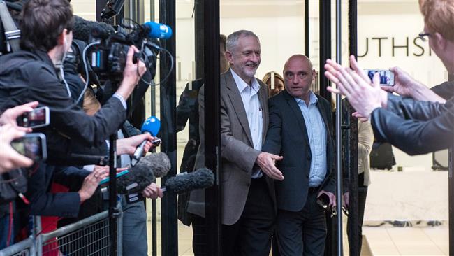 British Opposition Labour Party leader Jeremy Corbyn smiles as he greets supporters and members of the media after attending a meeting of Labour's National Executive Committee in London