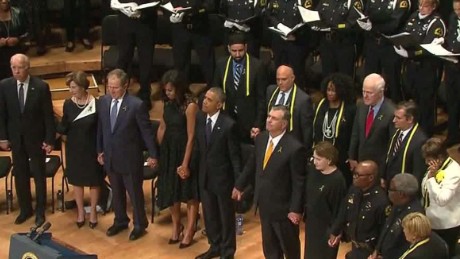 Former President George W. Bush shakes hands with President Barack Obama during an interfaith memorial service for the fallen police officers and members of the Dallas community Tuesday