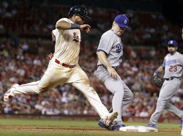 St. Louis Cardinals Alberto Rosario left grounds out as he is beaten to the bag by Los Angeles Dodgers starting pitcher Ross Stripling center as Dodgers