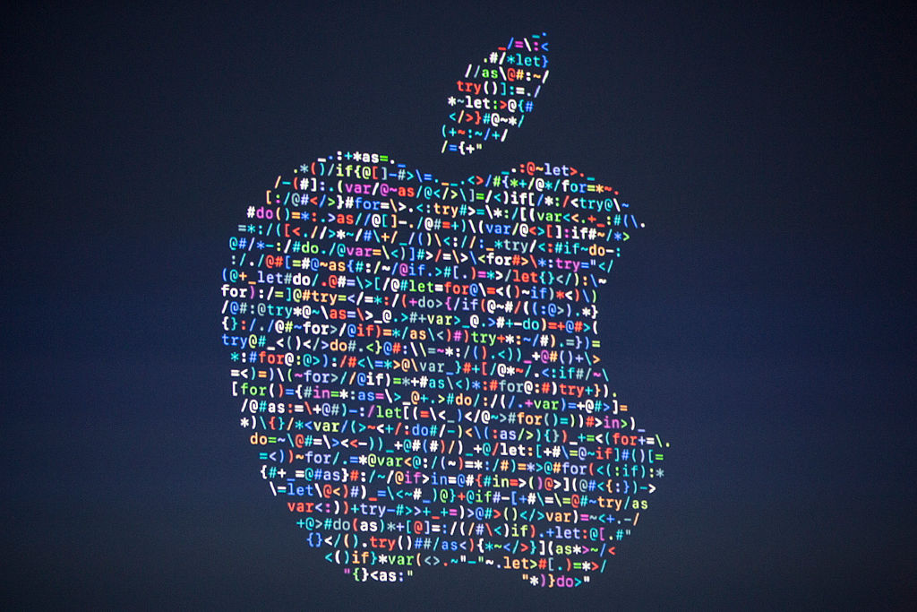 The Apple logo is projected on the screen at an Apple event at the Worldwide Developer's Conference