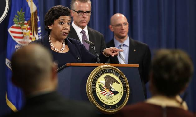 Attorney General Loretta Lynch left next to FBI Deputy Director Andrew Mc Cabe and IRS Criminal Division Chief Richard Weber speaks at a news conference Wednesday