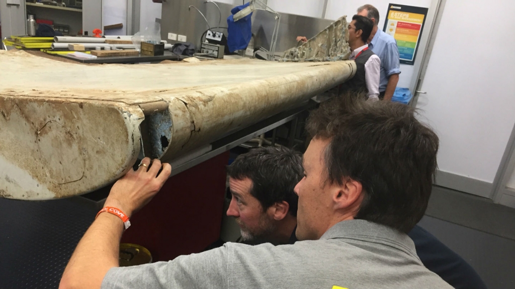 Malaysian and Australian investigators examine the piece of aircraft debris found on Pemba Island off the coast of Tanzania