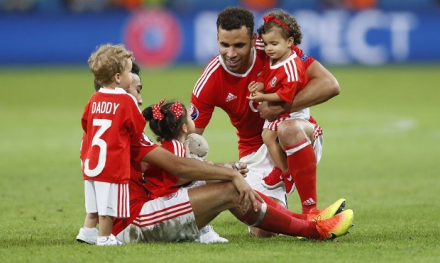 Man-of-the-match Robson Kanu and Neil Taylor celebrate with children at full time. — Reuters pics