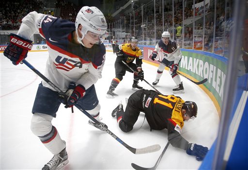 United States&#039 Auston Matthews left fights for the puck with Germanys Torsten Ankert during a Hockey World Championships Group B match