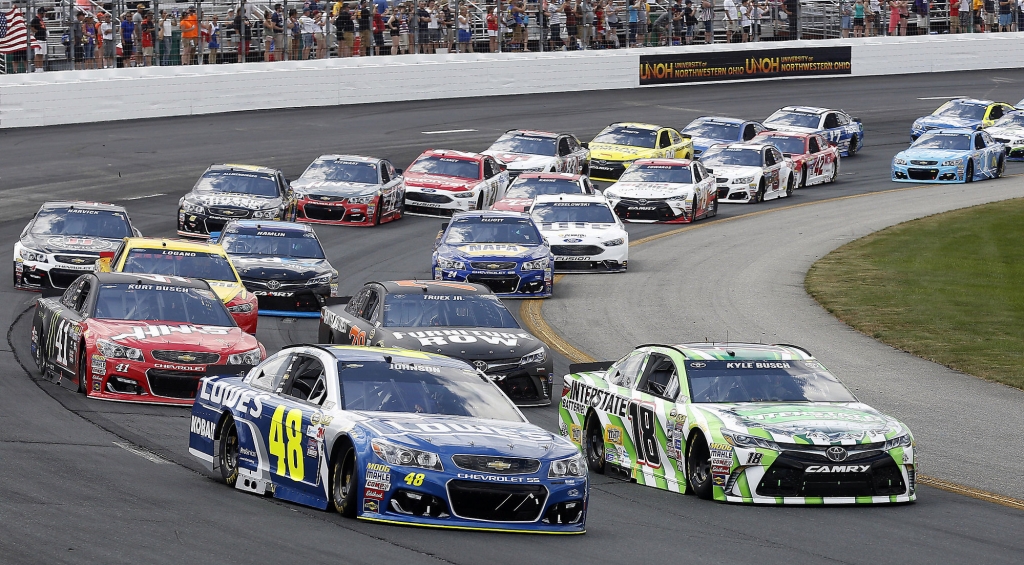 Jimmie Johnson and Kyle Busch lead the pack at the start of the New Hampshire 301 auto race at New Hampshire Motor Speedway Sunday