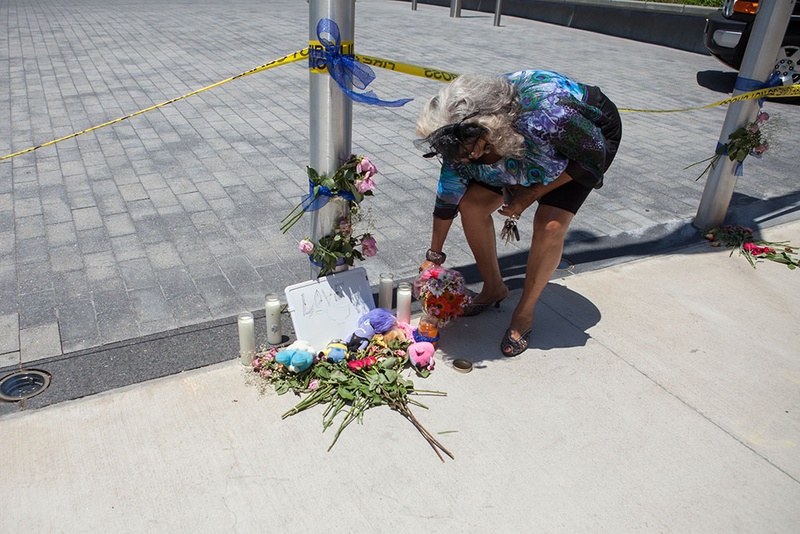 Clara Brown Trimble 63 put flowers next to a small memorial to police officers killed by sniper fire the night before in downtown Dallas following a peaceful Black Lives Matter Protest