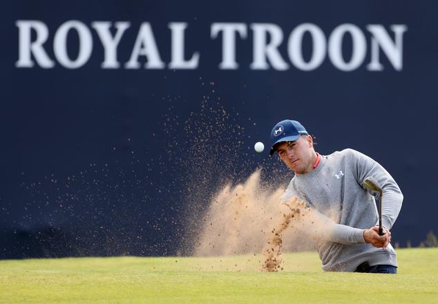 Jordan Spieth of the United States plays out of a sand trap on the 18th green during a practice round ahead of the British Open Golf Championship at the Roya