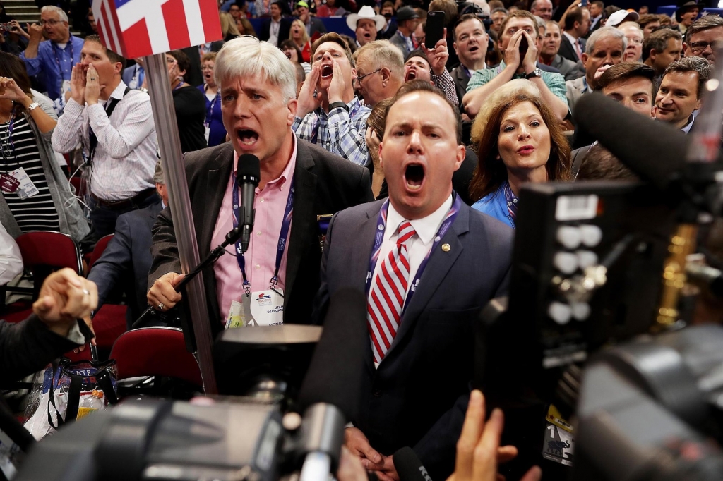 Sen. Mike Lee  ) and Phil Wright vice chair of the Utah State Delegation shout no to the adoption of rules without a roll call vote on the first day of the Republican National Convention at the Quicken Loans Arena in Cleveland