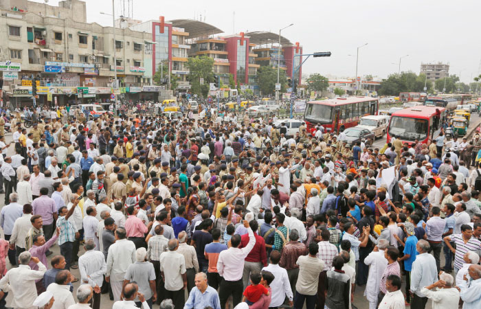 Members of India’s low-caste Dalit community block traffic and shout slogans in Ahmadabad India on Wednesday. — AP