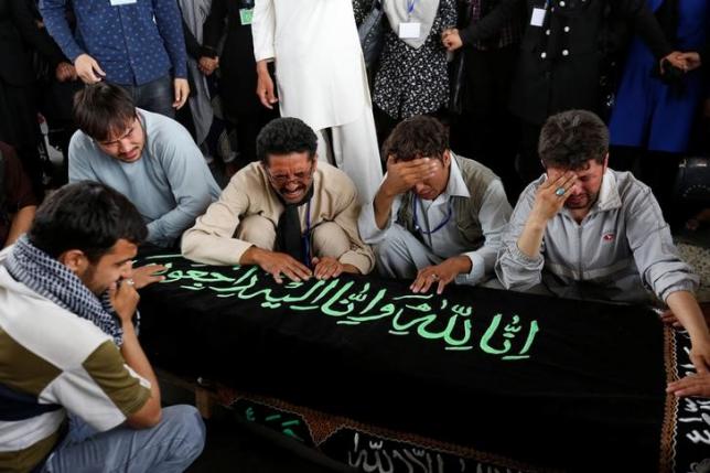 Men mourn over the coffin of a victim a day after a suicide attack in Kabul Afghanistan