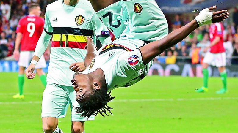 Michy Batshuayi does a flip after scoring Belgium’s third goal