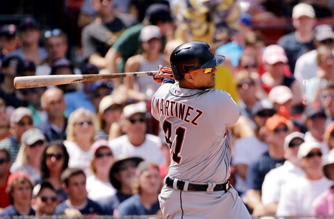 Detroit Tigers designated hitter Victor Martinez hits a 2-run single against the Boston Red Sox in the third inning of a baseball game at Fenway Park Wednesday