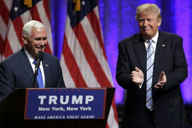 Republican US presidential candidate Donald Trump applauds Indiana governor Mike Pence after introducing him as vice presidential running mate in New York on 16 July