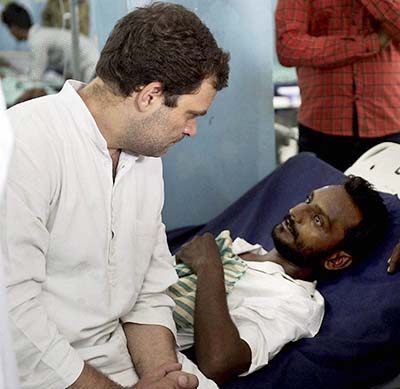 Rajkot Congress Vice President Rahul Gandhi visits the Dalit member who consumed poison in protest against assault on dalit members by cow protectors few days back at a hospital in Rajkot on Thursday. PTI