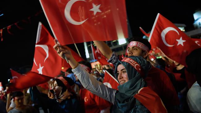 Supporters of Turkish President Recep Tayyip Erdogan hold Turkish national flags during a rally at Taksim Square in Istanbul