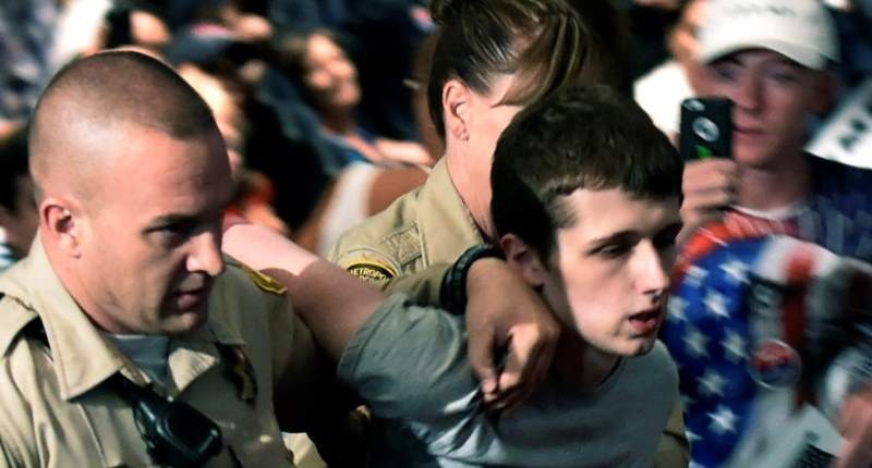 Las Vegas police lead Michael Steven Sandford from Republican U.S. presidential candidate Donald Trump's campaign rally at the Treasure Island Hotel & Casino in Las Vegas Nevada