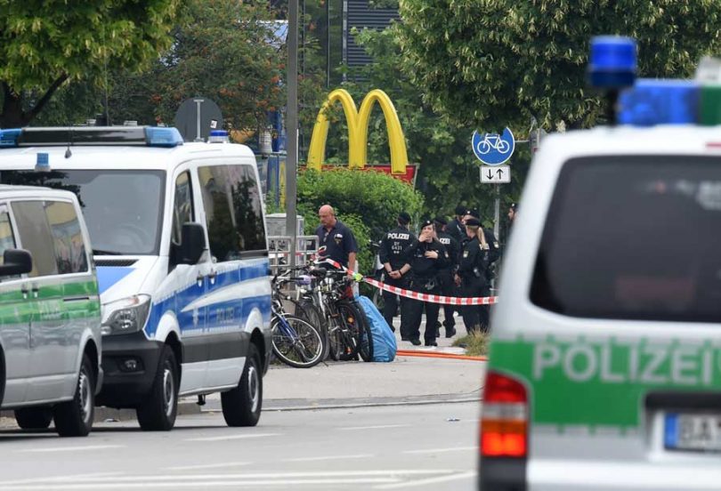 Police officers secure the area around a McDonald’s restaurant near the shopping mall Olympia Einkaufzentrum OEZ in Munich