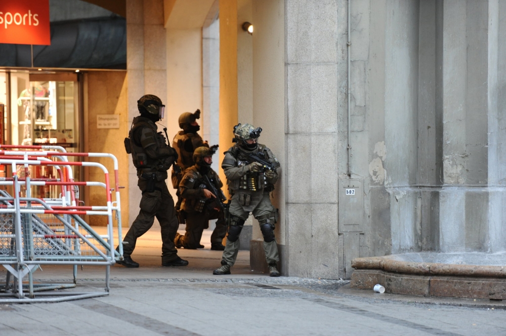 Heavily armed police forces operate at Karlsplatz square after a shooting in the Olympia shopping centre was reported in Munich southern Germany Friday