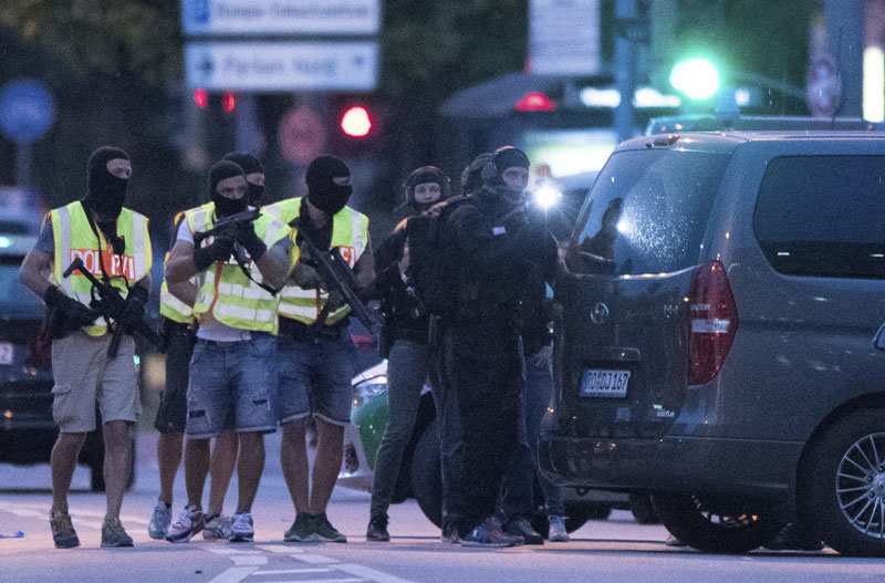 Special police forces prepare to search a neighbouring shopping centre outside the Olympia mall in Munich southern Germany on Friday