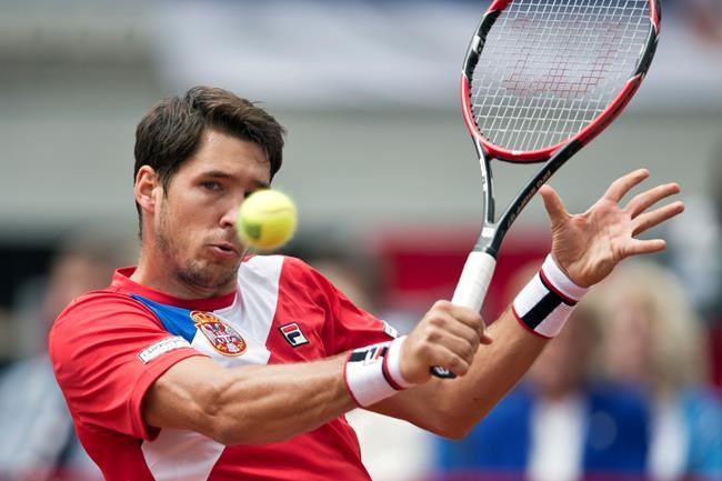 Serbia's Dusan Lajovic returns a ball to Britain's James Ward during their Davis Cup quarterfinal tennis match in Belgrade Serbia Saturday