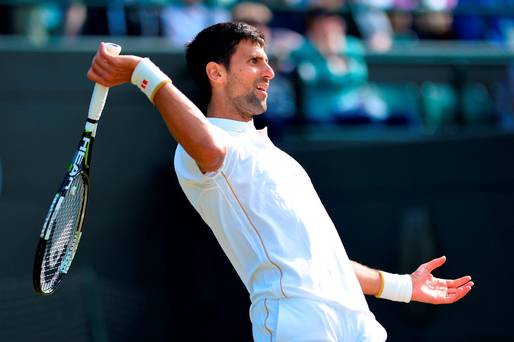 Serbia's Novak Djokovic reacts as he returns to US player Sam Querrey during their men's singles third round match on the sixth day of the 2016 Wimbledon Championships at The All England Lawn Tennis Club in Wimbledon