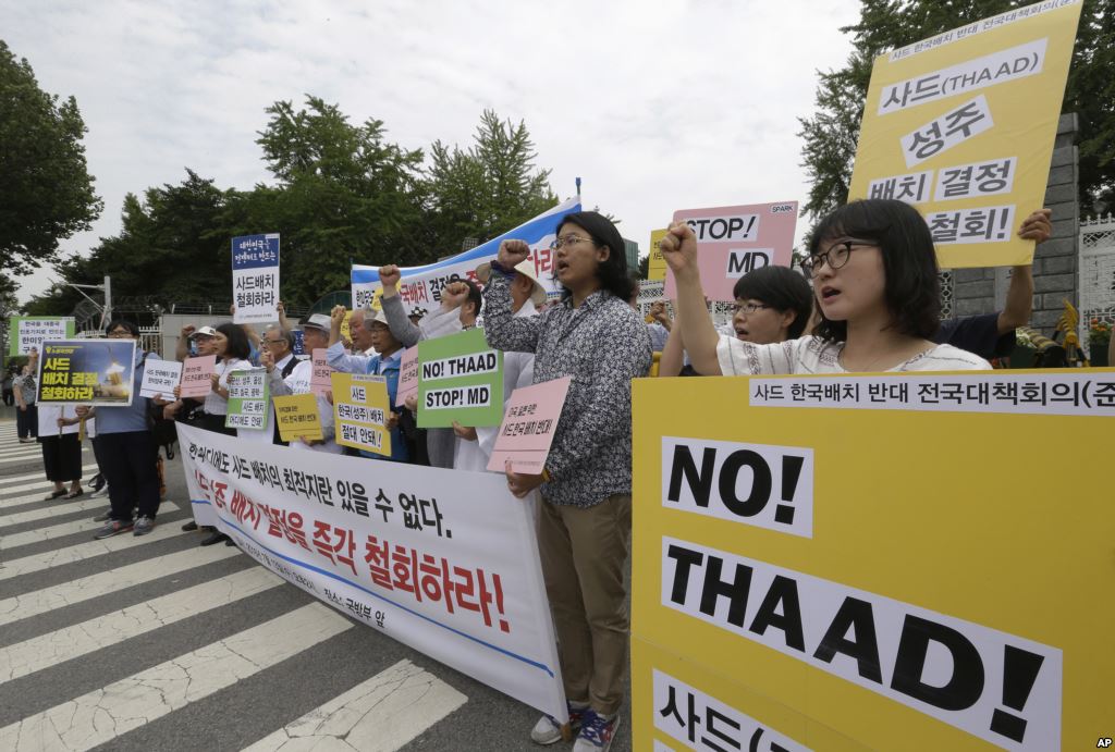 Protesters shout slogans during a rally to denounce deploying the Terminal High Altitude Area Defense or THAAD in front of the Defense Ministry in Seoul South Korea Wednesday