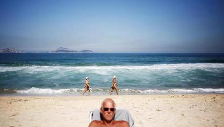 Above Beachgoers catch some sun at Impanema. Left Visitors take