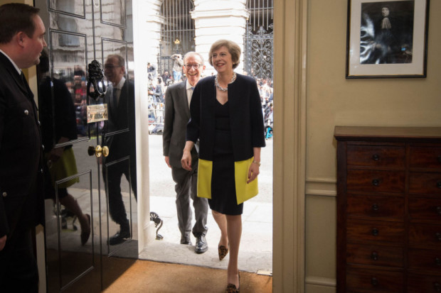 New Prime Minister Theresa May followed by her husband Philip John walks into 10 Downing Street London after meeting Queen Elizabeth II and accepting her invitation to become Prime Minister and form a new government