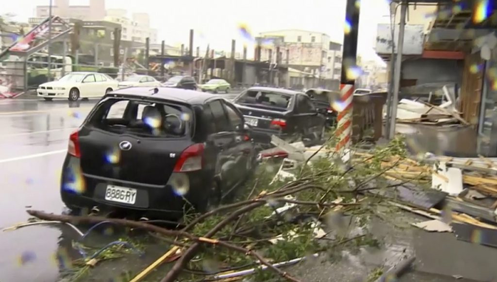 In this image made from video wind-blown debris from Typhoon Nepartak litters the street and damages a vehicle in Taitung south eastern Taiwan. Pic AP