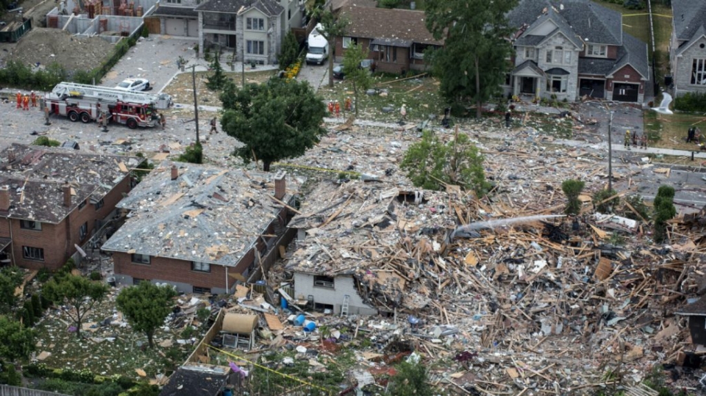 Firefighters examine debris after a house explosion in Mississauga last Tuesday